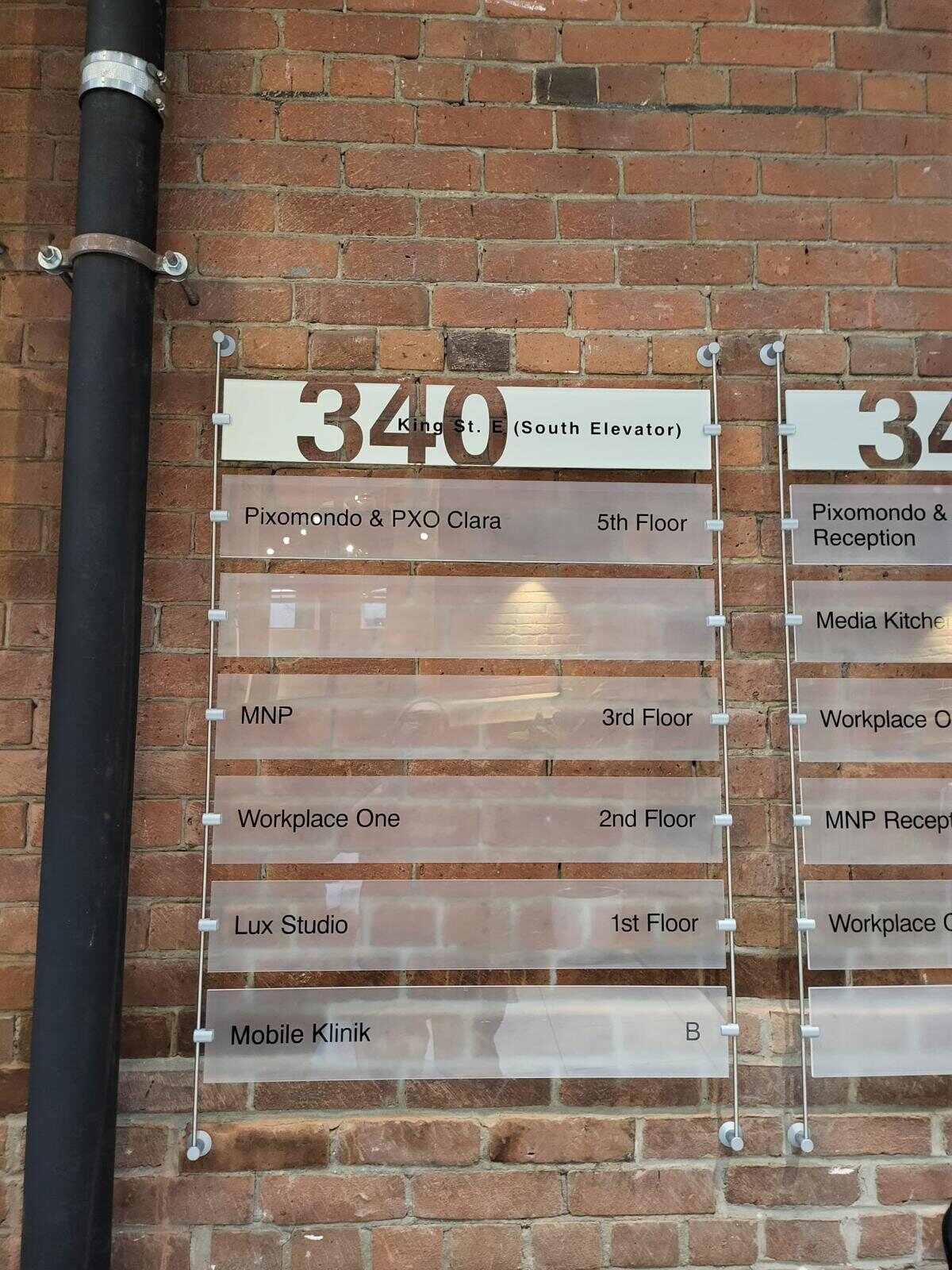 340 King Street East acrylic standoff tenant directory on a brick wall
